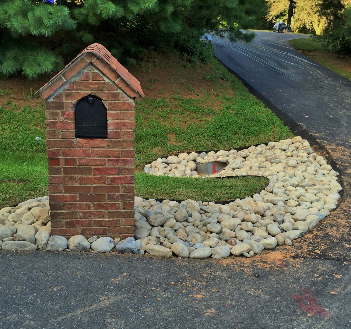 A mailbox and rock pit that was created at the end of the street